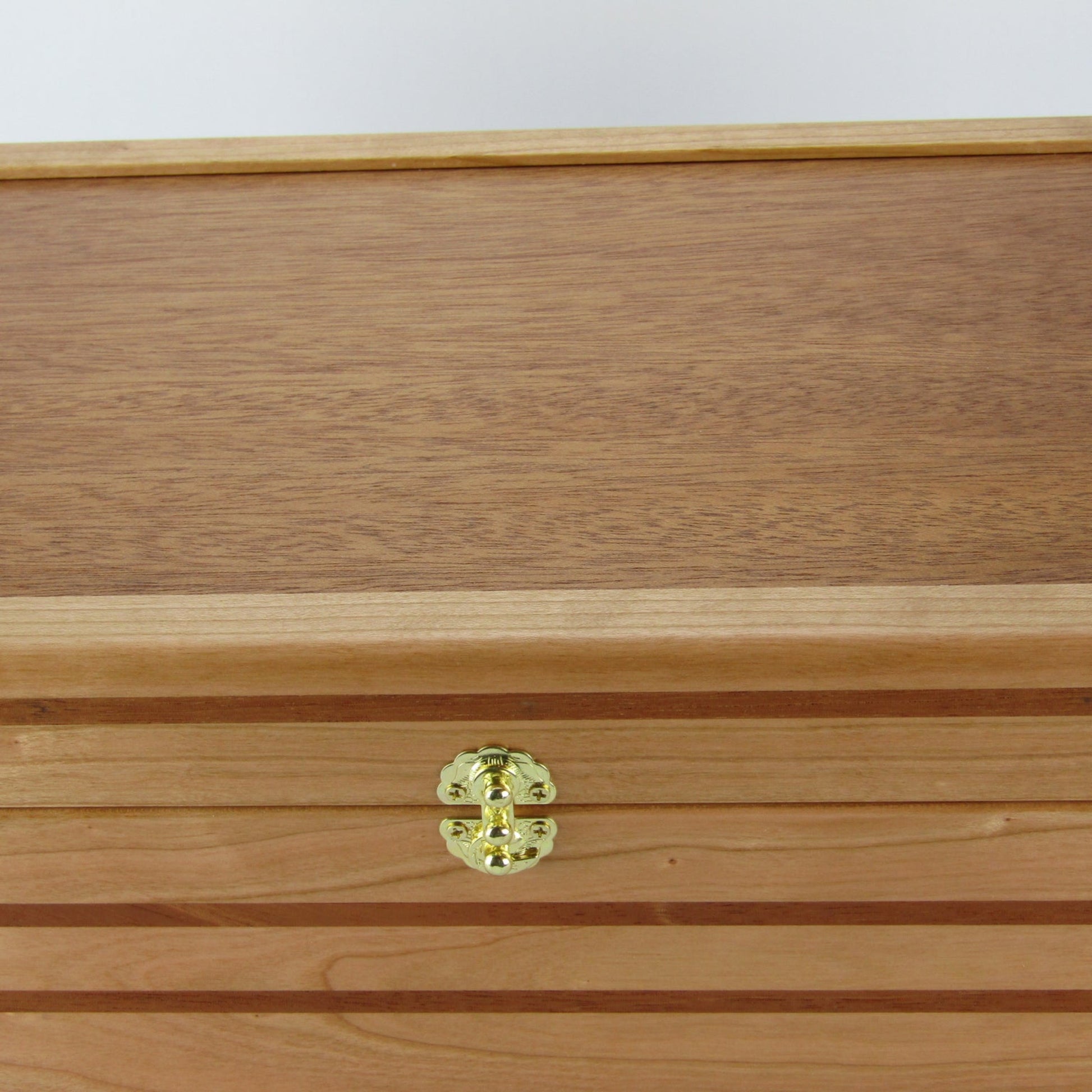 Lid details on wooden keepsake box handmade from domestic cherry and mahogany wood by A Finer Cut Woodworking.