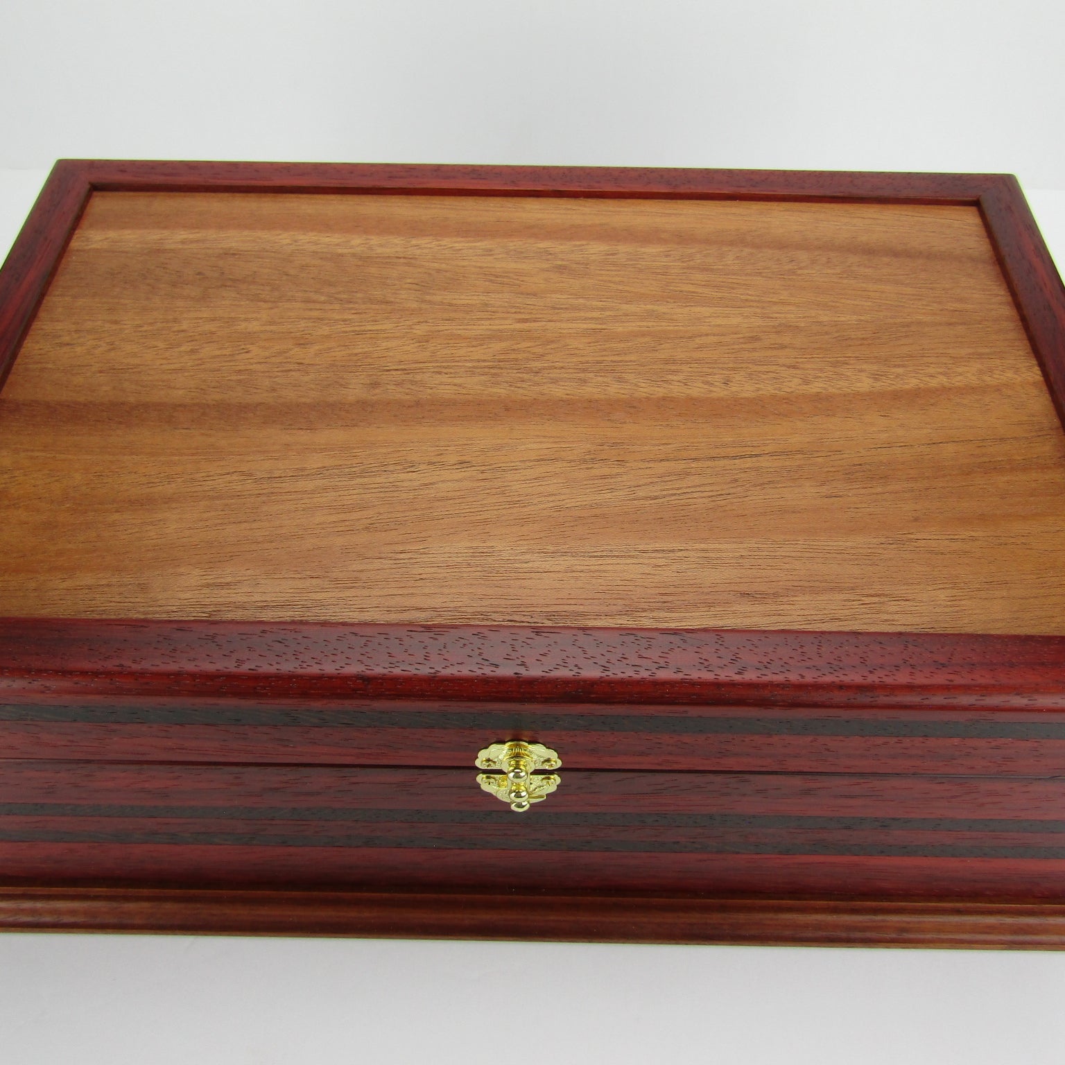 Top view of wooden keepsake box handmade from padauk, wenge, and cherry veneer by A Finer Cut Woodworking.